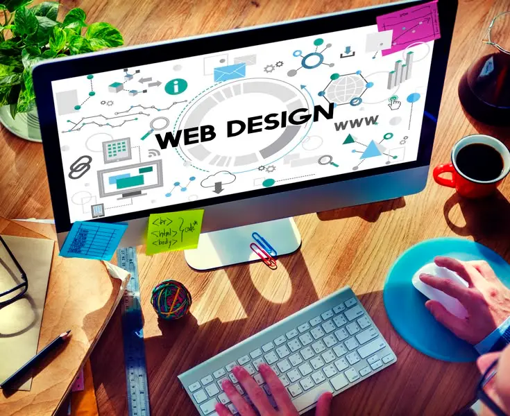 Computer monitor displaying web design graphics on desk, representing a web designer in Thrissur, Kerala